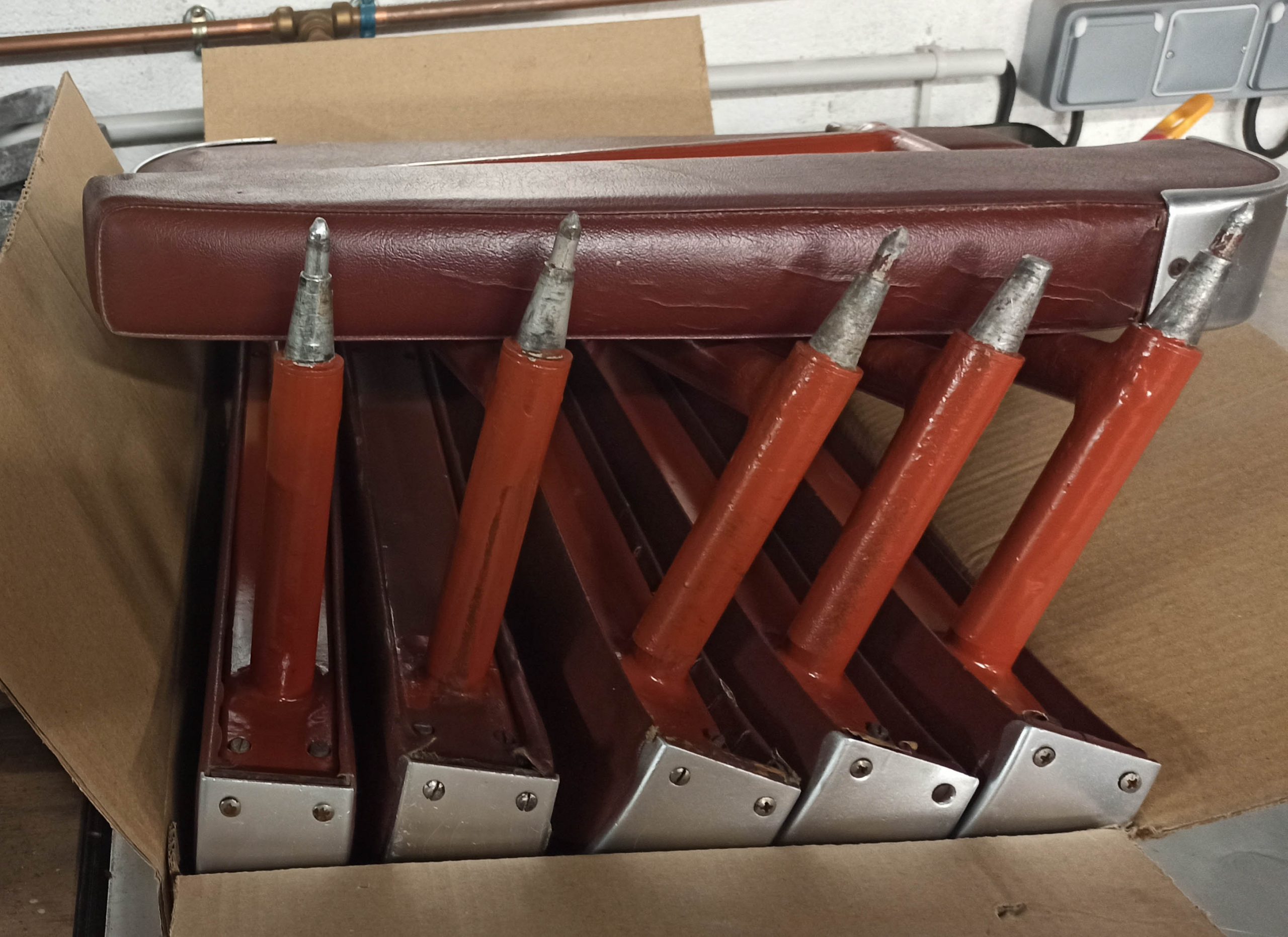 Armrests stored waiting to be reassembled on the Super Constellation F-BGNJ chairs