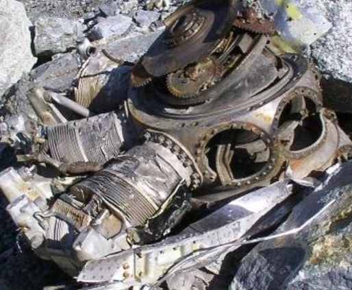 The remainder of the Malabar Princess engine lies among the rocks of Mont Blanc. This is one of the two crowns that houses 9 cylinders. This engine originally had 2 crowns. Only the central part that houses the cylinders remains. There are only 2 cylinders left on it. The other locations are just empty holes. The metal is deformed and torn, as if shredded.